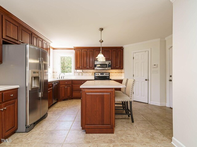 2213 Ravens Creek Ct, Raleigh, NC 27603 - kitchen with light countertops, crown molding, a breakfast bar area, decorative backsplash, and appliances with stainless steel finishes
