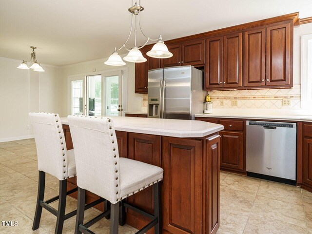 2213 Ravens Creek Ct, Raleigh, NC 27603 - kitchen with ornamental molding, backsplash, light countertops, and stainless steel appliances