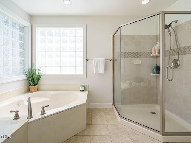 2213 Ravens Creek Ct, Raleigh, NC 27603 - bathroom with a wealth of natural light, tile patterned flooring, a garden tub, and a stall shower