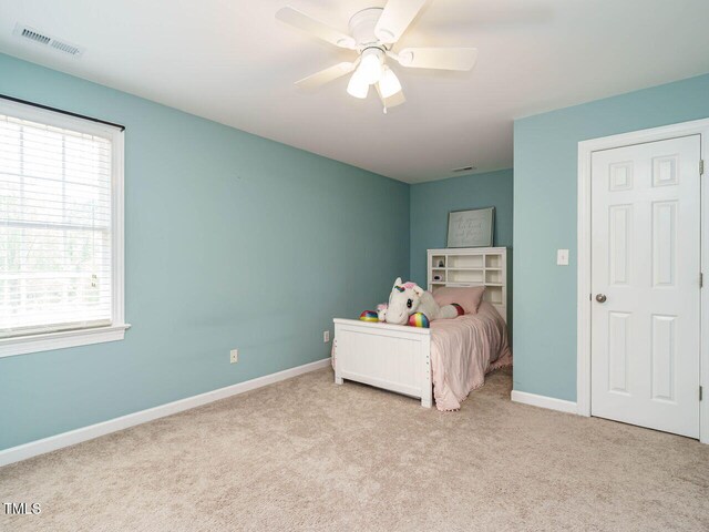2213 Ravens Creek Ct, Raleigh, NC 27603 - unfurnished bedroom with carpet flooring, baseboards, a ceiling fan, and visible vents