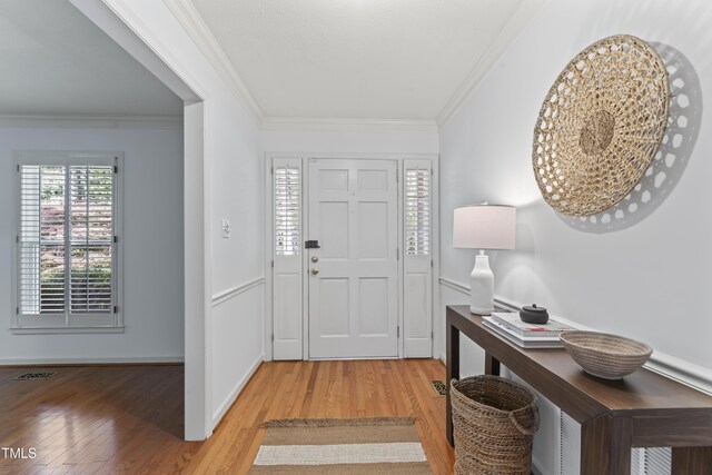 3911 Hope Valley Rd, Durham, NC 27707 - foyer entrance with light wood finished floors, ornamental molding, and baseboards