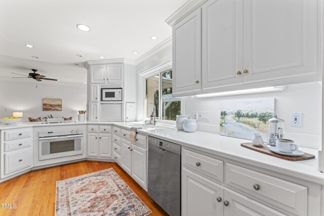 3911 Hope Valley Rd, Durham, NC 27707 - kitchen with white appliances, white cabinetry, ceiling fan, light countertops, and ornamental molding