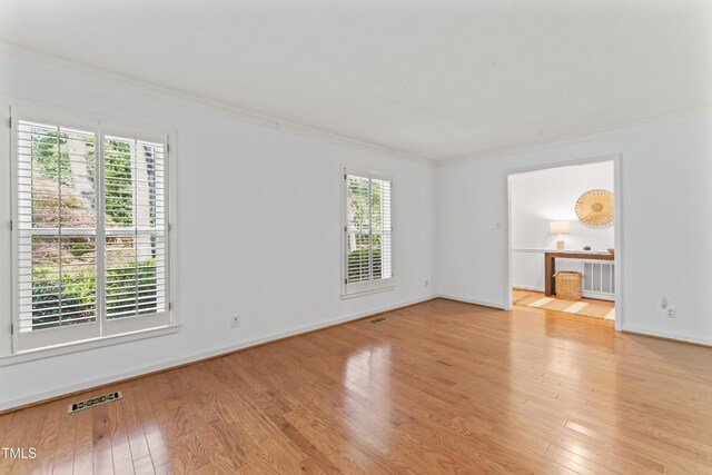 3911 Hope Valley Rd, Durham, NC 27707 - empty room featuring ornamental molding, plenty of natural light, wood-type flooring, and baseboards
