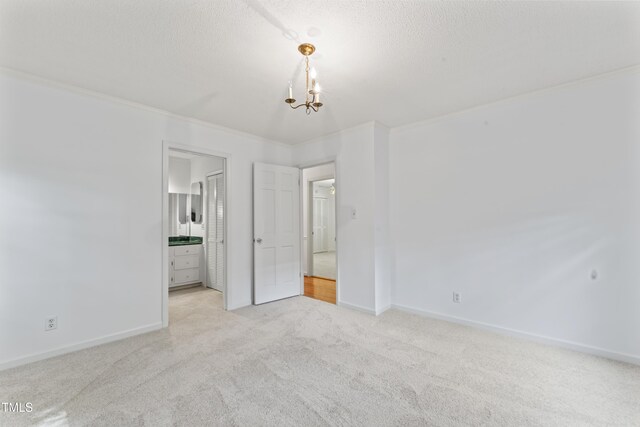 3911 Hope Valley Rd, Durham, NC 27707 - unfurnished bedroom with crown molding, carpet flooring, baseboards, a chandelier, and ensuite bath