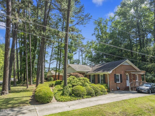 3911 Hope Valley Rd, Durham, NC 27707 - view of front of house with brick siding, a front lawn, and driveway