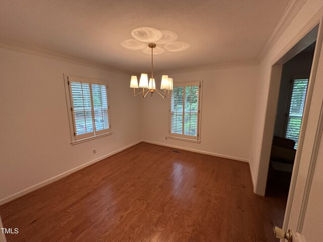 3911 Hope Valley Rd, Durham, NC 27707 - unfurnished room featuring crown molding, a chandelier, dark wood finished floors, a textured ceiling, and baseboards