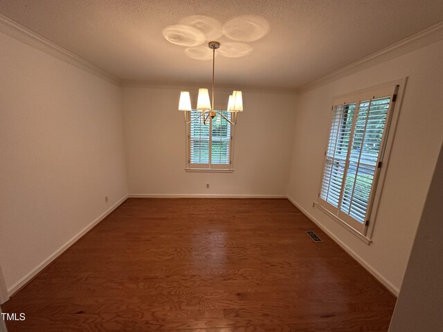 3911 Hope Valley Rd, Durham, NC 27707 - empty room with a chandelier, dark wood finished floors, ornamental molding, baseboards, and a textured ceiling