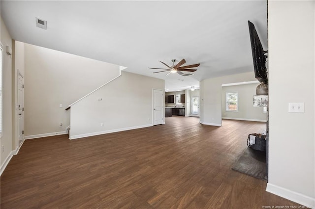 4644 Woodline Dr, Fayetteville, NC 28314 - unfurnished living room featuring dark wood-type flooring, baseboards, a ceiling fan, and visible vents
