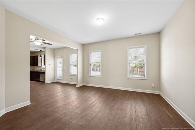 4644 Woodline Dr, Fayetteville, NC 28314 - unfurnished living room featuring dark wood finished floors, visible vents, baseboards, and ceiling fan
