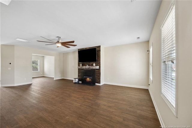4644 Woodline Dr, Fayetteville, NC 28314 - unfurnished living room with a brick fireplace, baseboards, ceiling fan, and dark wood-style floors