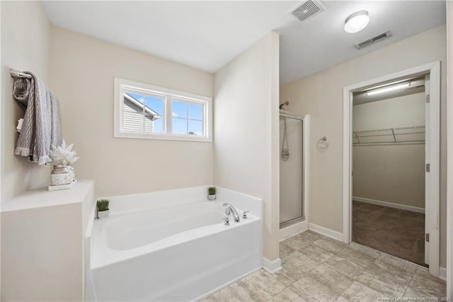 4644 Woodline Dr, Fayetteville, NC 28314 - full bath featuring a shower stall, a spacious closet, a garden tub, and visible vents