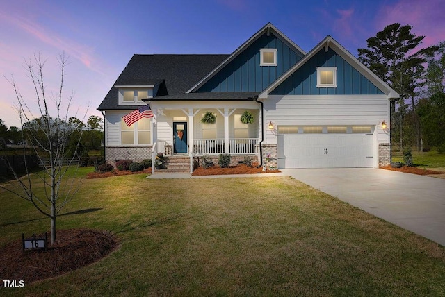 craftsman-style house with driveway, board and batten siding, a garage, a lawn, and a porch
