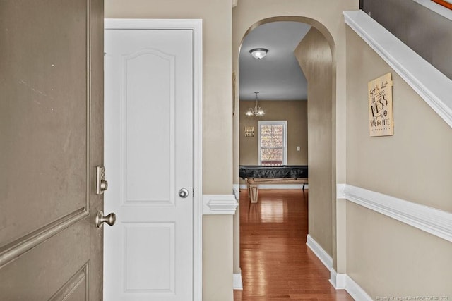 178 Tun Tavern Dr, Cameron, NC 28326 - corridor featuring arched walkways, wood finished floors, baseboards, and a chandelier