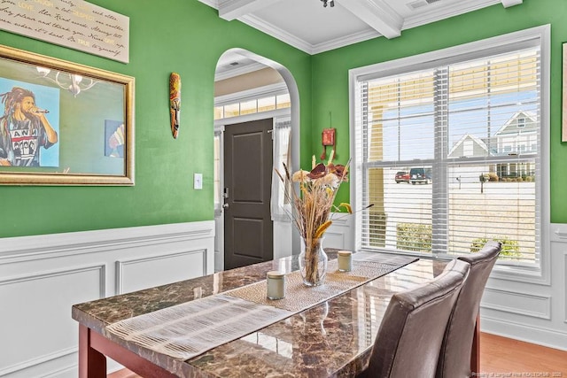178 Tun Tavern Dr, Cameron, NC 28326 - dining space featuring a decorative wall, beamed ceiling, crown molding, arched walkways, and plenty of natural light