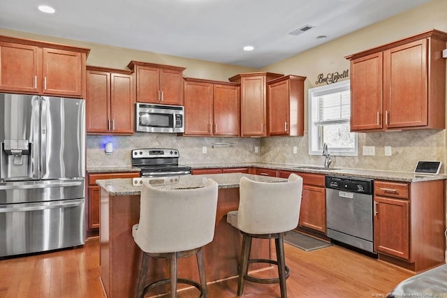 178 Tun Tavern Dr, Cameron, NC 28326 - kitchen with appliances with stainless steel finishes, a sink, wood finished floors, a kitchen island, and recessed lighting