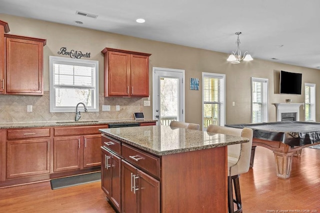 178 Tun Tavern Dr, Cameron, NC 28326 - kitchen with a sink, a breakfast bar, light wood-style flooring, open floor plan, and recessed lighting