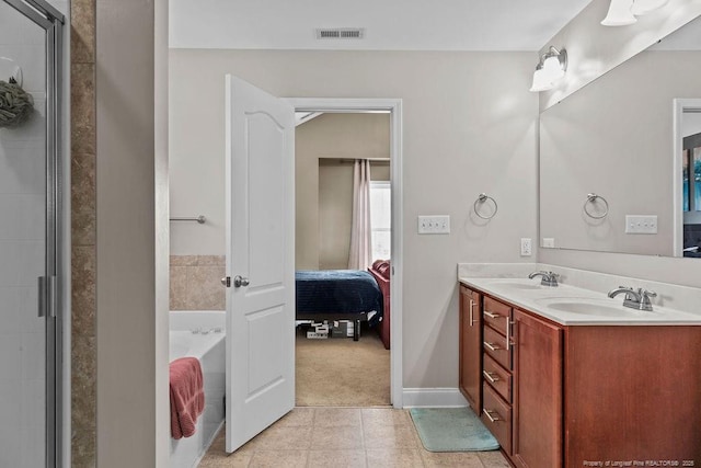 178 Tun Tavern Dr, Cameron, NC 28326 - ensuite bathroom featuring a bath, double vanity, tile patterned flooring, a shower with door, and baseboards