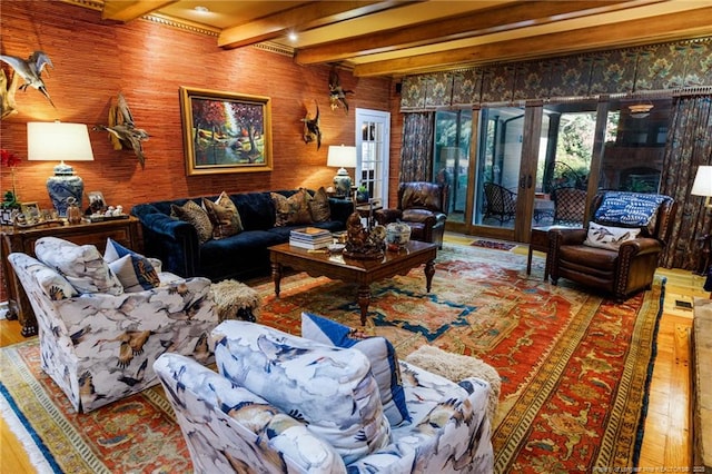 living room with beamed ceiling, wood finished floors, and french doors