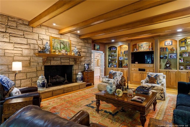 living room with a fireplace, light wood-type flooring, and beam ceiling
