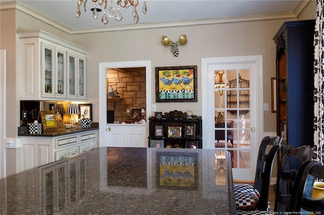 dining area featuring crown molding and a notable chandelier