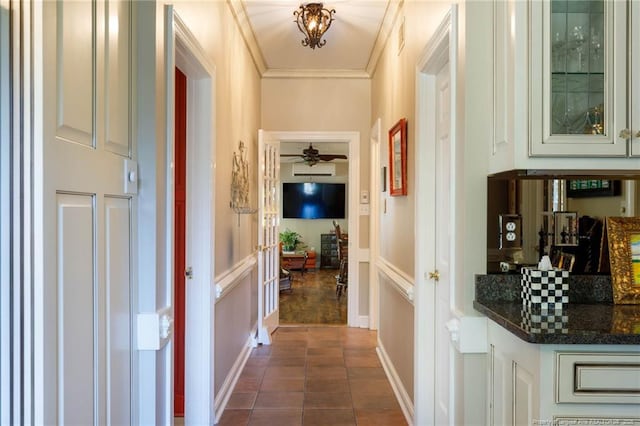 hall with ornamental molding, dark tile patterned flooring, and visible vents