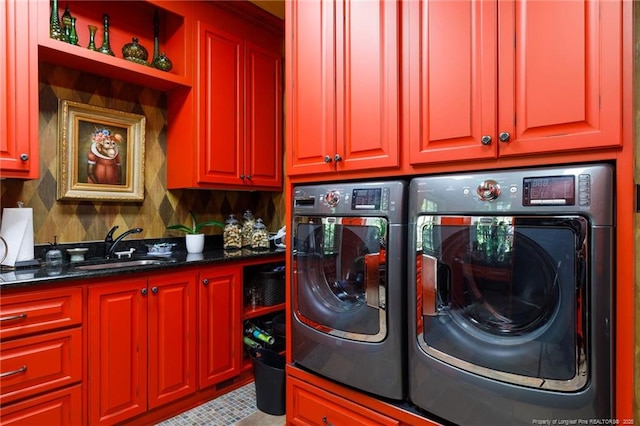 laundry area with a sink, washer and clothes dryer, and cabinet space