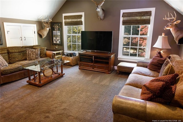 living area featuring vaulted ceiling and carpet flooring