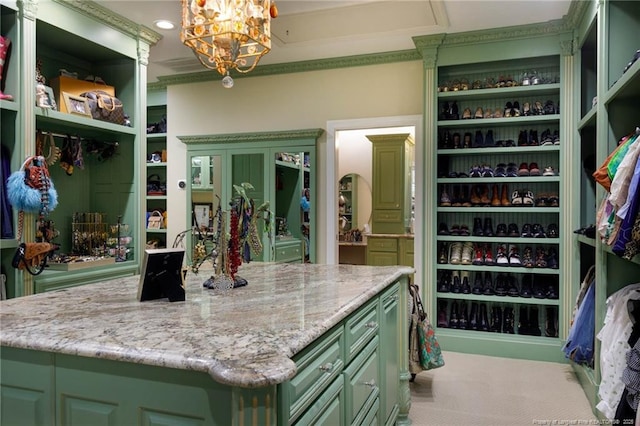 walk in closet with carpet floors and a chandelier