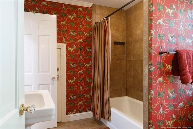 bathroom featuring baseboards, wallpapered walls, tile patterned flooring, and shower / bath combo with shower curtain