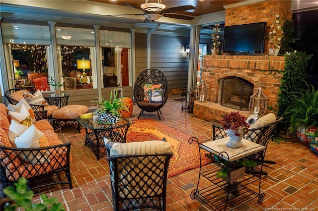 exterior space featuring a brick fireplace, brick floor, ceiling fan, and ornate columns