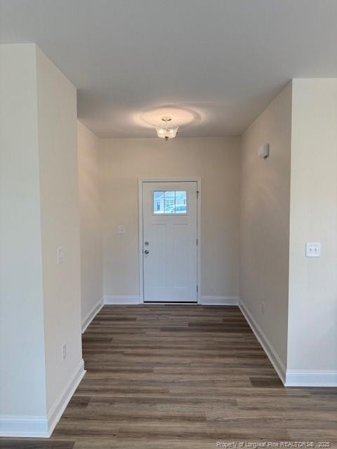 entryway with baseboards and wood finished floors