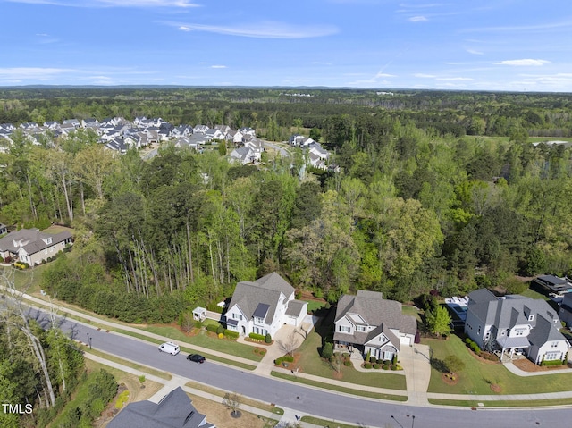 birds eye view of property featuring a residential view and a wooded view