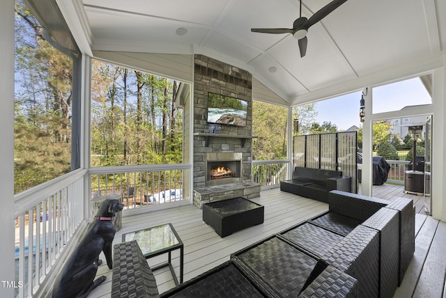 exterior space featuring an outdoor living space with a fireplace and ceiling fan