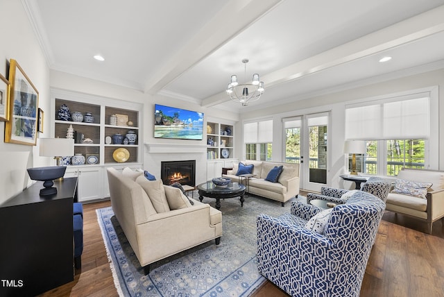 living room with beamed ceiling, a warm lit fireplace, wood finished floors, and ornamental molding