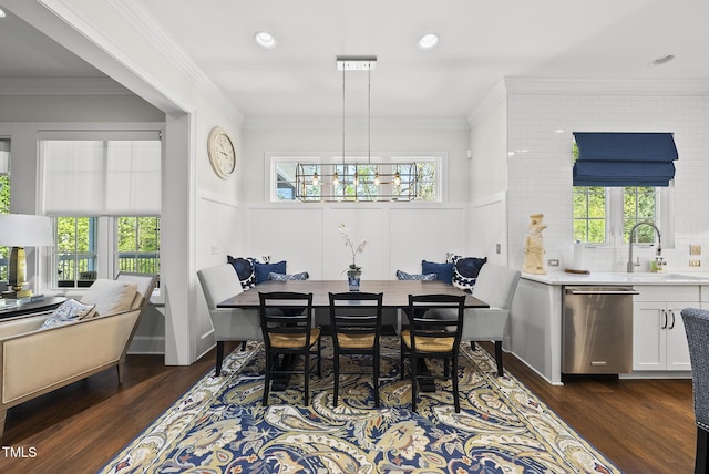 dining area featuring wainscoting, dark wood finished floors, and a healthy amount of sunlight