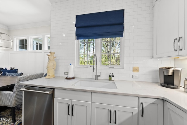 kitchen with dishwasher, a sink, backsplash, and crown molding