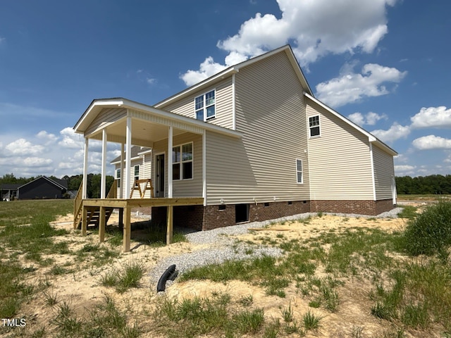 view of side of home featuring crawl space and a wooden deck