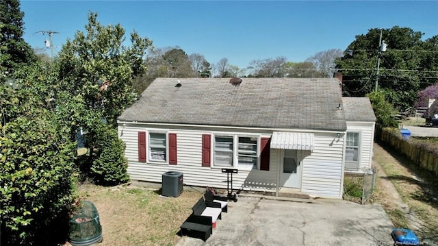 back of house with cooling unit, a yard, and entry steps