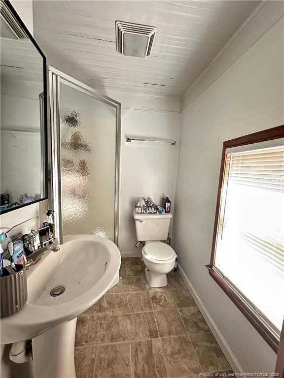 full bathroom featuring a stall shower, baseboards, visible vents, and toilet