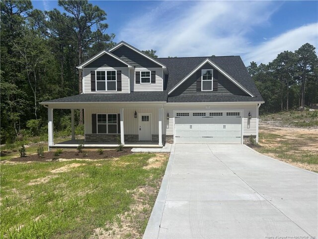 505 Chason Rd, Lumber Bridge, NC 28357 - view of front of house featuring covered porch, concrete driveway, a garage, and roof with shingles