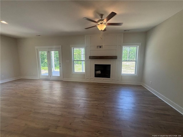 505 Chason Rd, Lumber Bridge, NC 28357 - unfurnished living room with baseboards, dark wood-style flooring, a fireplace, and a ceiling fan