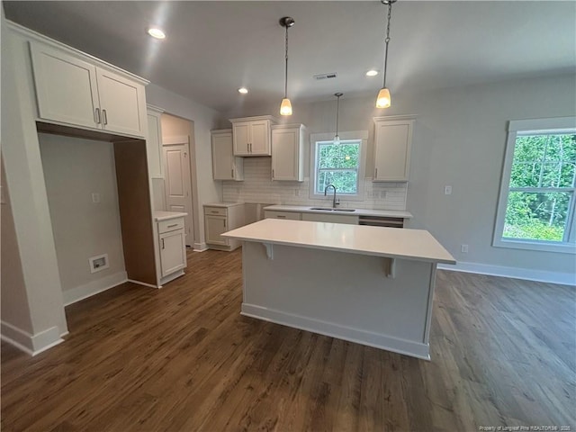 505 Chason Rd, Lumber Bridge, NC 28357 - kitchen featuring a sink, baseboards, decorative backsplash, dark wood-type flooring, and a kitchen island