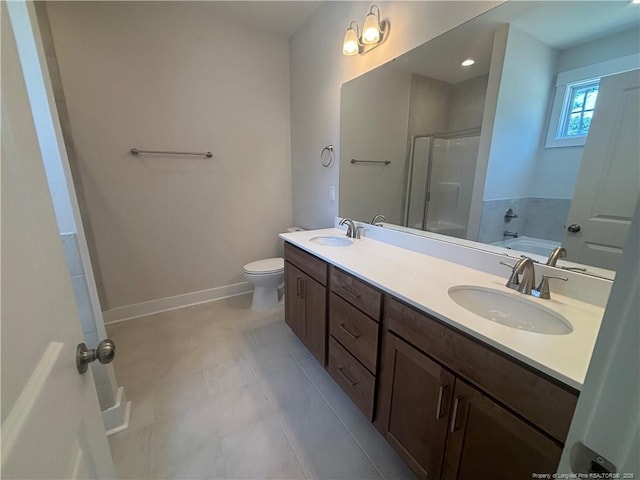 505 Chason Rd, Lumber Bridge, NC 28357 - bathroom with a shower stall, baseboards, double vanity, a bathtub, and toilet