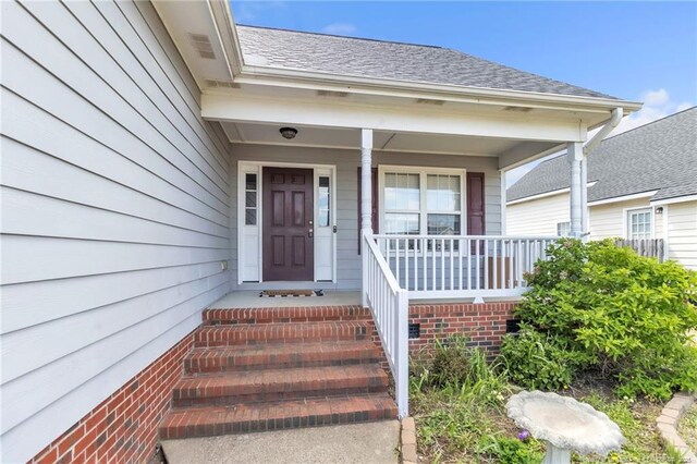 2220 Chasewater Rd, Fayetteville, NC 28306 - view of exterior entry with a porch and a shingled roof