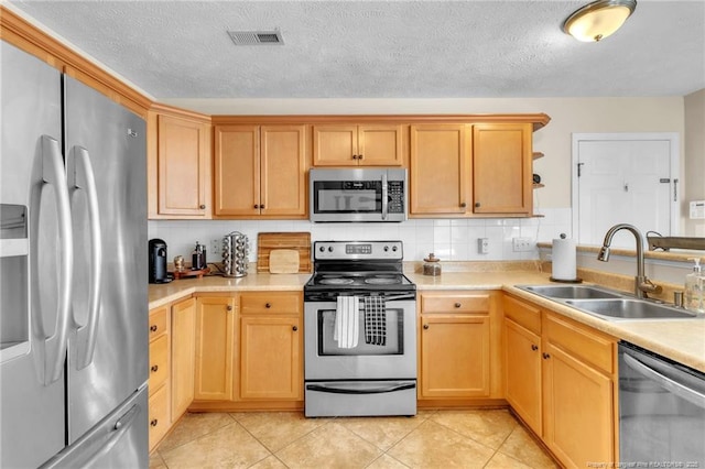 2220 Chasewater Rd, Fayetteville, NC 28306 - kitchen featuring light countertops, a sink, light brown cabinets, and stainless steel appliances