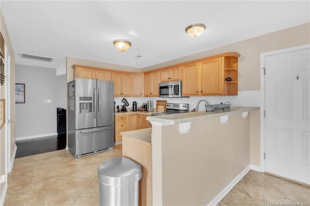 2220 Chasewater Rd, Fayetteville, NC 28306 - kitchen with light brown cabinetry, stainless steel appliances, a peninsula, and visible vents