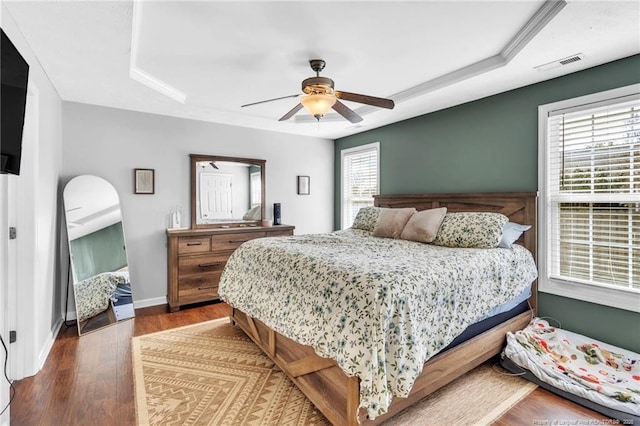 2220 Chasewater Rd, Fayetteville, NC 28306 - bedroom with ceiling fan, baseboards, wood finished floors, a tray ceiling, and visible vents