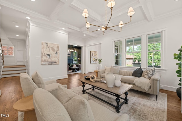 living room with beamed ceiling, coffered ceiling, wood finished floors, and a chandelier