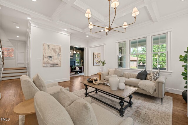 909 N Gregson St, Durham, NC 27701 - living room with beamed ceiling, coffered ceiling, wood finished floors, and a chandelier