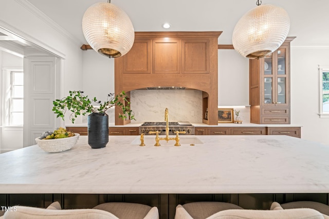 kitchen with crown molding, a kitchen breakfast bar, and light stone countertops